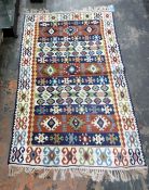 Eastern rug on a brown ground, assorted hooked medallion decoration, in browns, pinks, greens,