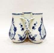 Delft fuddling cup with three beakers, of baluster form with interlocking handles, underglaze blue