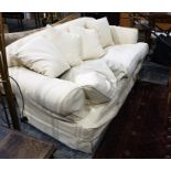 Two-seat sofa in light yellow loose covers