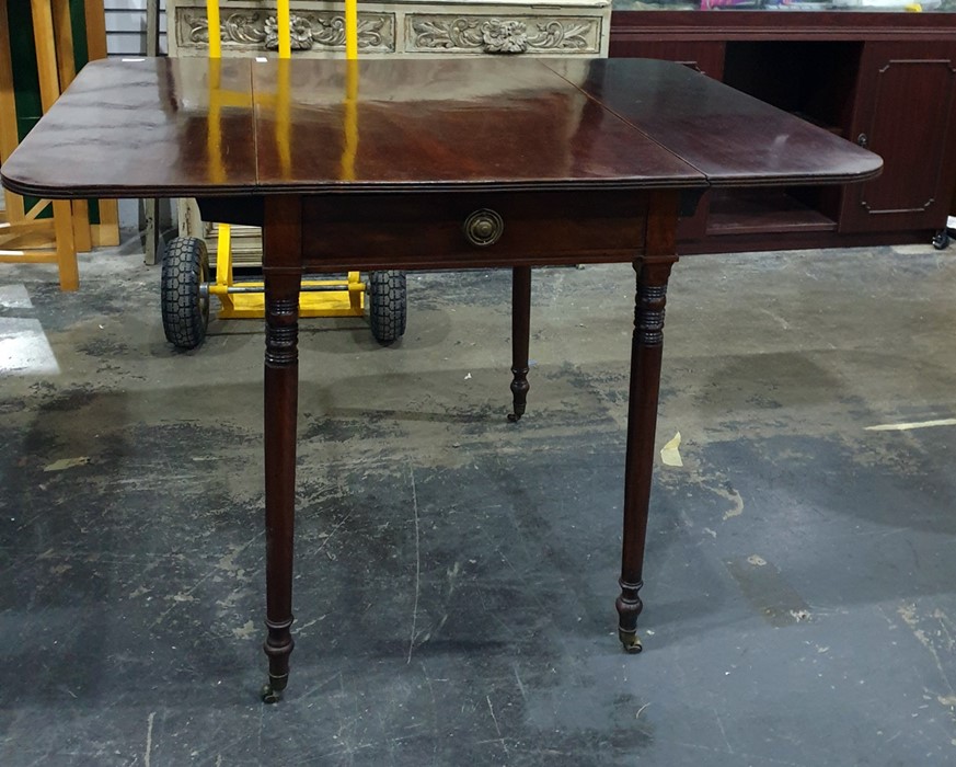 19th century mahogany pembroke table on turned supports to brass caps and castors, 84cm