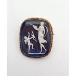 Gold-coloured metal and iridescent ground cameo style brooch, rounded oblong, with Cupid and Psyche,