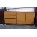 Mid 20th century teak sideboard with three drawers to the left hand side, two cupboard doors to