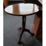 Oval top mahogany side table on baluster turned supports to three cabriole legs