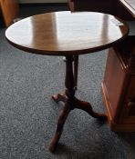 Oval top mahogany side table on baluster turned supports to three cabriole legs