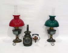 Two oil lamps and one further lamp and a spirit burner