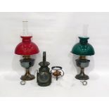 Two oil lamps and one further lamp and a spirit burner