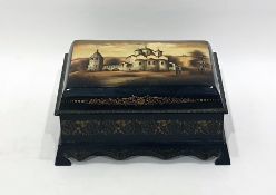 Russian Fedoskino lacquer decorated box featuring building with figures conversing outside,