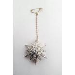 Gold and diamond set star brooch, the central brilliant cut diamond approx 0.3ct and surrounded by