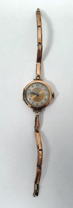 Lady's 9ct gold wristwatch with circular dial, Arabic numerals on 9ct gold expanding bracelet strap