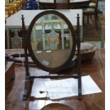 19th century mahogany oval toilet mirror on turned supports and stretcher