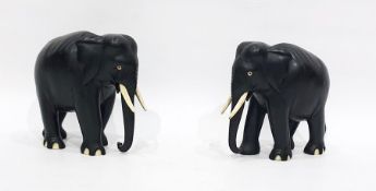 Pair of 20th century carved ebony Indian elephants, with bone tusks and toes, 15 cm tall