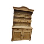 Old pine dresser with arched pediment, open shelf plate rack with four spice drawers, pair of frieze