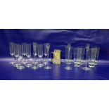 Set of eight champagne flute glasses, large hi-ball glasses, set of four glass candlesticks and an