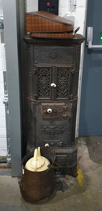 Old decorative cast iron stove, a pair of pierced fretwork panel doors enclosing cooking compartment