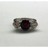 18ct gold ring set with central ruby (possibly heat treated) and two diamonds