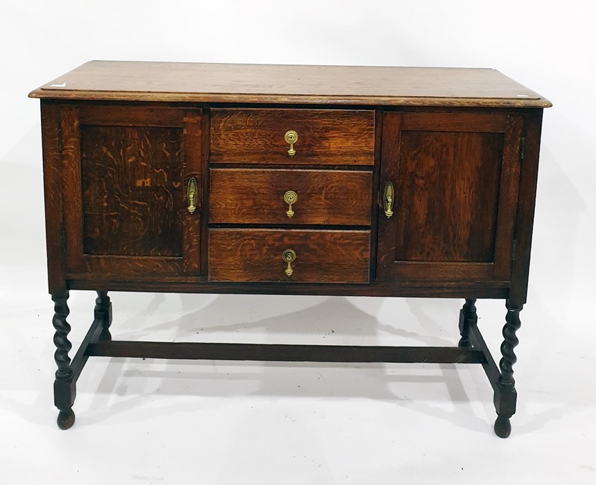 Early 20th century oak sideboard with moulded edge, above three central drawers flanked by