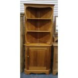 Modern pine Ercol corner cupboard with three open shelves, cupboard below enclosing shelf, on