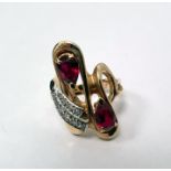 Gold dress ring set with two rows of diamonds and two pear-shaped red stones, marked '14K', size M