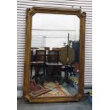 19th century rectangular wall mirror with canted corners, in a gilt carved wood frame, 181cm x 120cm