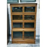 Late 19th century oak and inlaid four-sectional bookcase, each section with glazed doors and