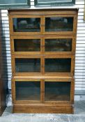 Late 19th century oak and inlaid four-sectional bookcase, each section with glazed doors and