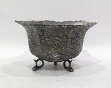 Indian white metal sugar bowl of circular flared form, with wavy rim, decorated with scrolls and