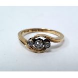 Early 20th century 18ct gold three-stone diamond ring in scroll setting, set one central and two