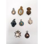 Six various silver and silver-coloured fobs, some with engraving and two military cap badges