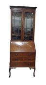 20th century mahogany bureau bookcase with moulded pediment above astragal-glazed doors enclosing