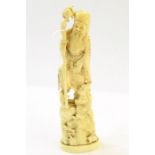 19th century Japanese carved ivory group of elderly man with wooden staff and attendant, on