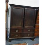 19th century mahogany linen press with dentil moulded cornice above the two-panelled cupboard