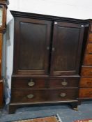 19th century mahogany linen press with dentil moulded cornice above the two-panelled cupboard