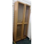 Pale oak glazed cupboard, with adjustable shelves, height 200 cms