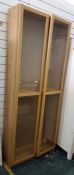 Pale oak glazed cupboard, with adjustable shelves, height 200 cms