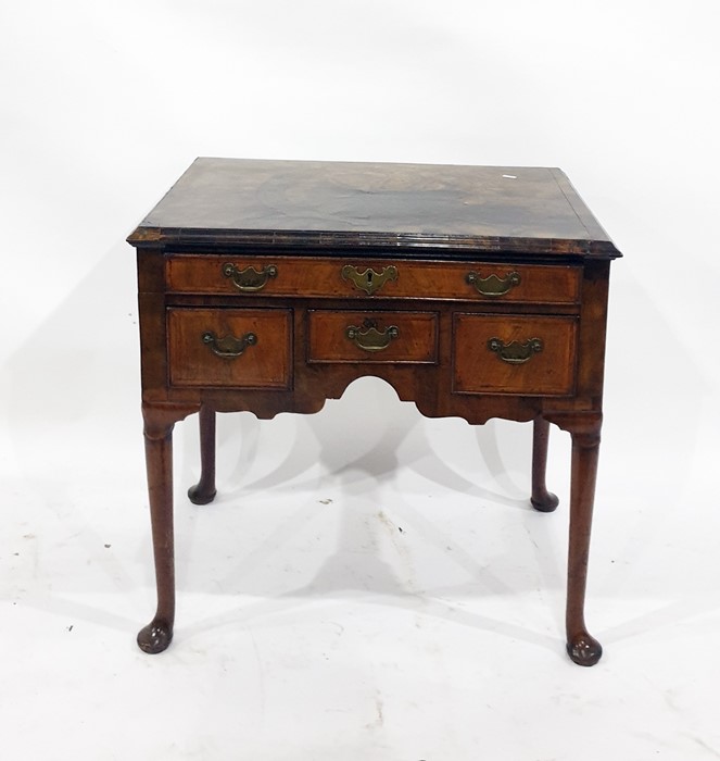 Possibly 18th century oyster walnut lowboy with moulded edge above one long and three short drawers,