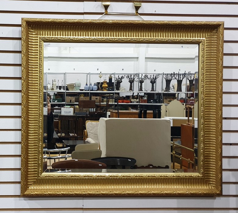 Rectangular wall mirror with bevelled edge in a gilt effect frame