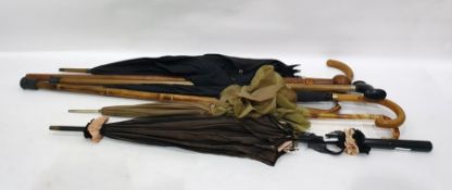 Carved wooden walking stick with knop handle, two black umbrellas, one with gold collar, the other