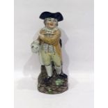 19th century Toby character jug standing figure with tri-form hat, clay pipe, holding jug of ale, on