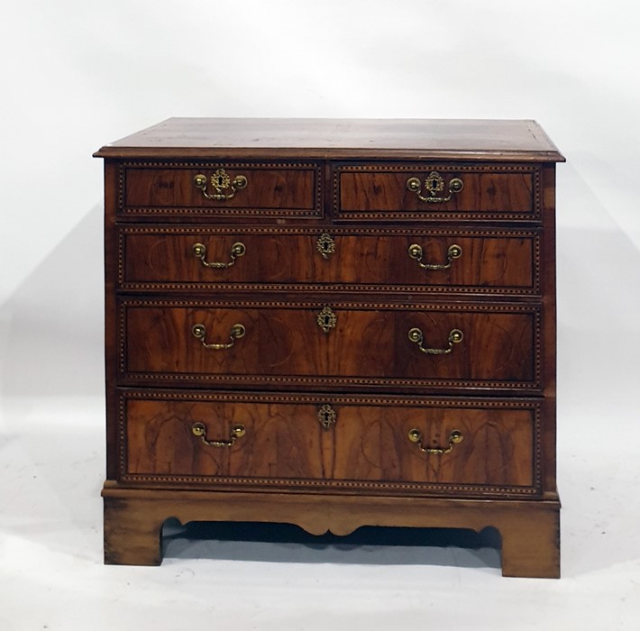 Early 19th century and later walnut and inlaid chest of drawers, the rectangular top with applied