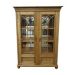 Modern pine glazed storage cupboard with straight moulded cornice, the glazed doors enclosing