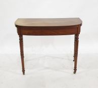 19th century mahogany foldover tea table with ebony stringing to the frieze, on turned supports to