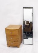 Oak bowfront bedside chest of three drawers and a mirror (2)