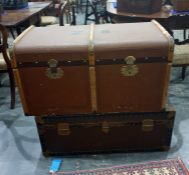 Large wood bound canvas travelling trunk and a tin travelling trunk carrying shipping labels (2)