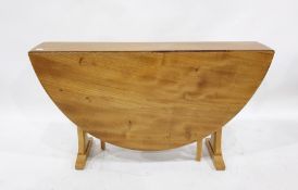 Light elm Ercol drop-leaf dining table with beech pedestal end supports, the top 127cm x 139cm