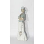 Lladro figure of a lady holding a Pekingese in her arms, with umbrella, approx 38cm high