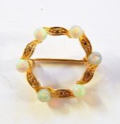 Gold-coloured metal and opal circlet brooch, foliate design set with six spherical opals