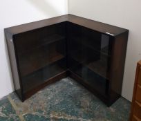 Corner bookshelf unit with sliding glass doors enclosing shelves