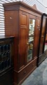 Edwardian walnut wardrobe with single glazed door,