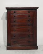 19th century mahogany table-top collectors Wellington chest of seven drawers, raised upon plinth