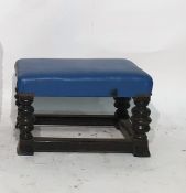 Low stained oak footstool with blue leatherette seat, turned supports and stretchered base